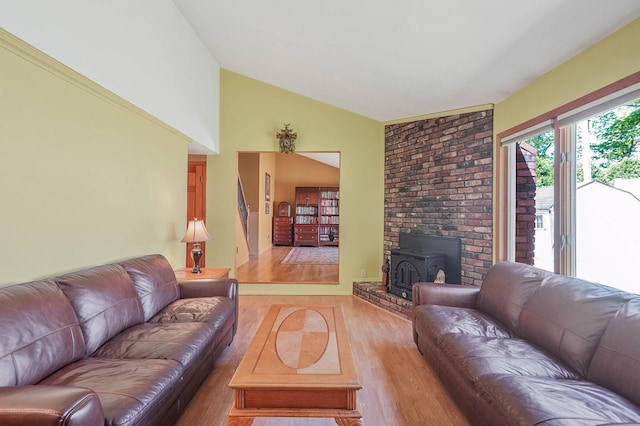 23 John St, Port Jefferson Station, NY 11776 - living area featuring lofted ceiling, light wood finished floors, and a wood stove