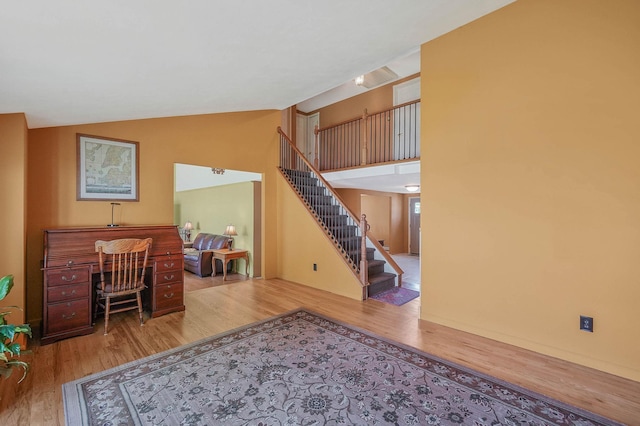 23 John St, Port Jefferson Station, NY 11776 - living room with wood finished floors, lofted ceiling, and stairs
