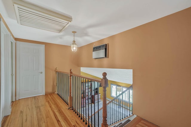 23 John St, Port Jefferson Station, NY 11776 - corridor featuring an upstairs landing, light wood-type flooring, and heating unit