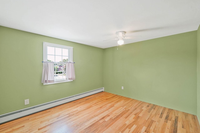 23 John St, Port Jefferson Station, NY 11776 - empty room featuring a baseboard heating unit, wood finished floors, and a ceiling fan