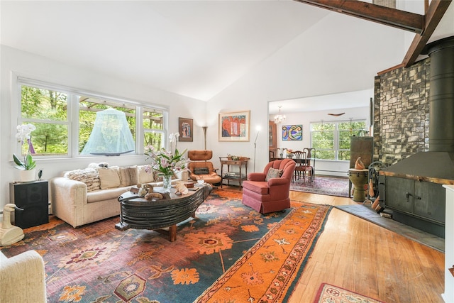 10 S Mountain Pond, Garrison, NY 10524 - living area with a wood stove, plenty of natural light, high vaulted ceiling, wood-type flooring, and baseboard heating