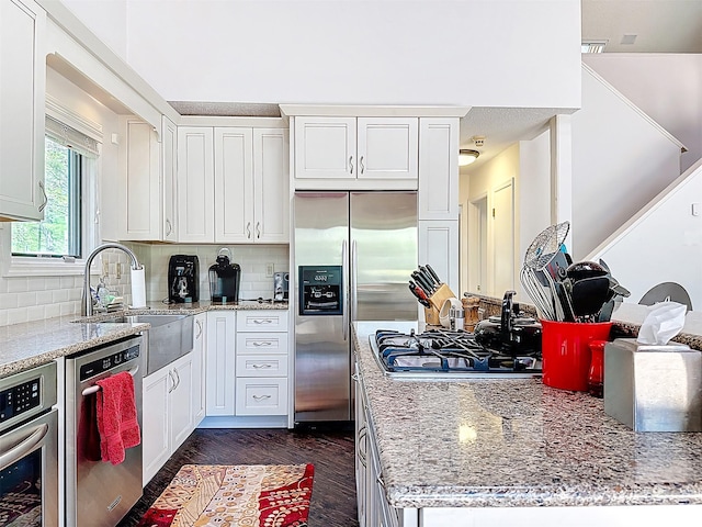 5 Water Lilly Ln, Monticello, NY 12701 - kitchen with appliances with stainless steel finishes, a sink, tasteful backsplash, and white cabinetry