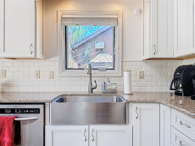 5 Water Lilly Ln, Monticello, NY 12701 - kitchen featuring stainless steel dishwasher, a sink, white cabinets, backsplash, and light stone countertops