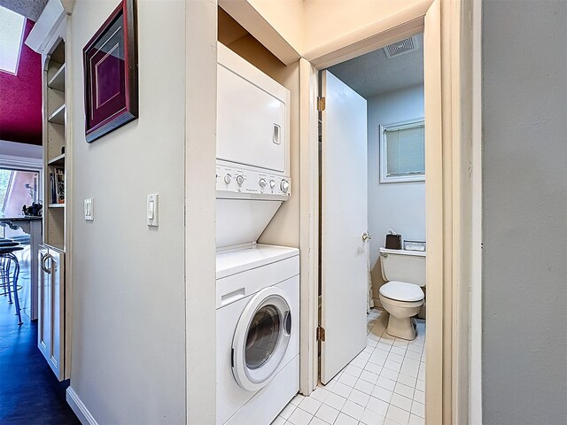 5 Water Lilly Ln, Monticello, NY 12701 - clothes washing area featuring stacked washer / drying machine and tile patterned floors