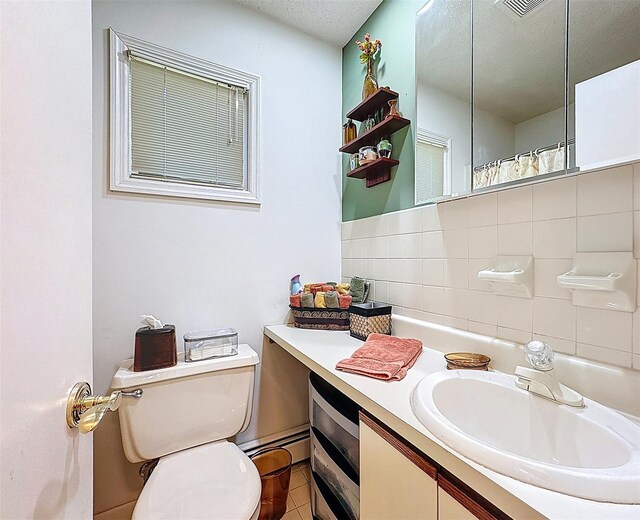 5 Water Lilly Ln, Monticello, NY 12701 - bathroom with vanity, toilet, a baseboard heating unit, decorative backsplash, and tile patterned flooring