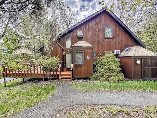 5 Water Lilly Ln, Monticello, NY 12701 - chalet / cabin with a shed, an outbuilding, a deck, and a wall mounted air conditioner