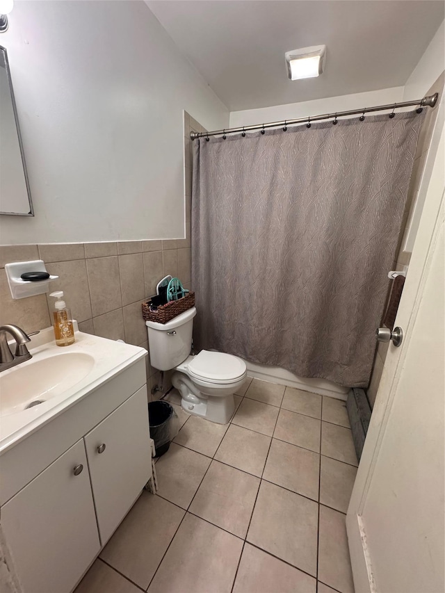 702 Tower Ct, Uniondale, NY 11553 - bathroom featuring toilet, vanity, wainscoting, tile patterned floors, and tile walls