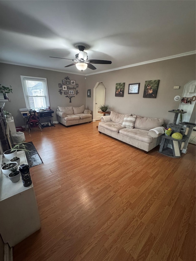 702 Tower Ct, Uniondale, NY 11553 - living room with arched walkways, wood finished floors, ceiling fan, and crown molding