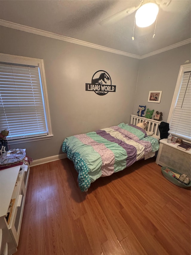 702 Tower Ct, Uniondale, NY 11553 - bedroom featuring wood finished floors, crown molding, a ceiling fan, and baseboards