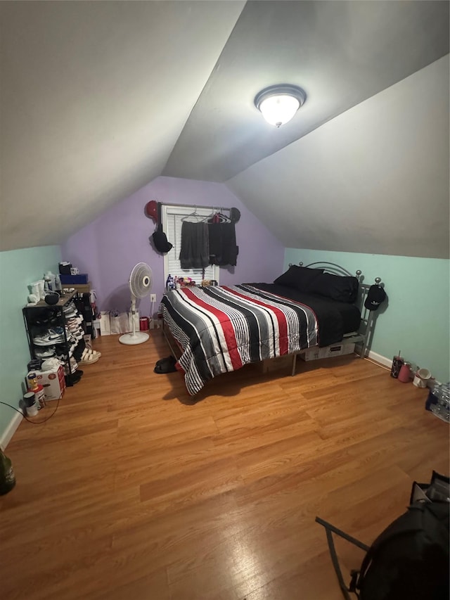 702 Tower Ct, Uniondale, NY 11553 - bedroom with wood finished floors, vaulted ceiling, and baseboards