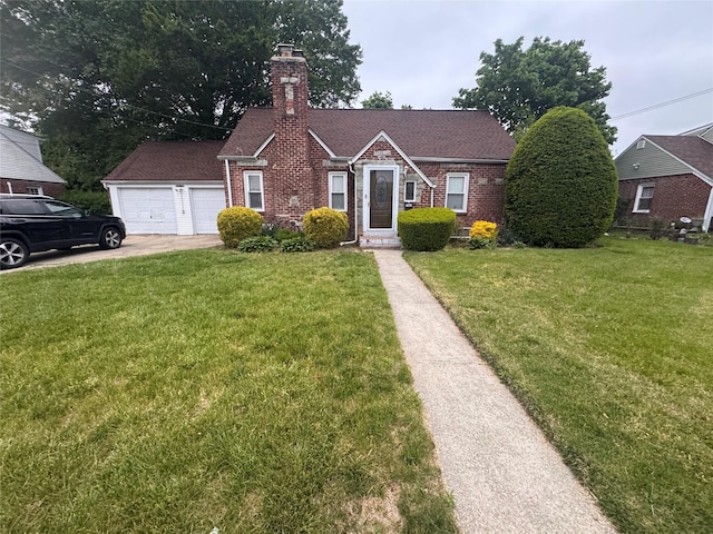 702 Tower Ct, Uniondale, NY 11553 - view of front of property with a chimney, a front yard, a garage, and brick siding