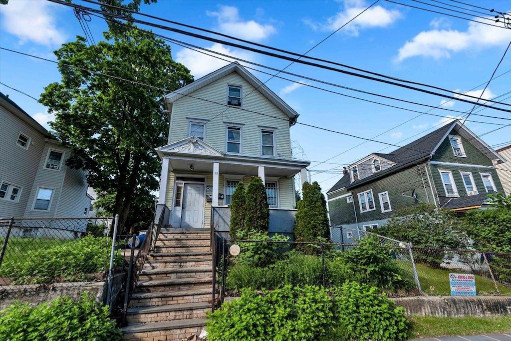 28 Grove St, Mount Vernon, NY 10550 - view of front facade with covered porch and a fenced front yard