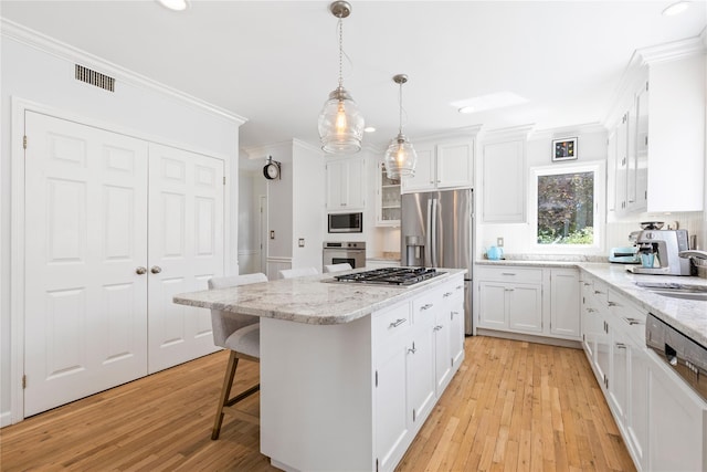 2 Robert Crisfield Pl, Rye, NY 10580 - kitchen featuring stainless steel appliances, ornamental molding, white cabinetry, light wood-type flooring, and a center island
