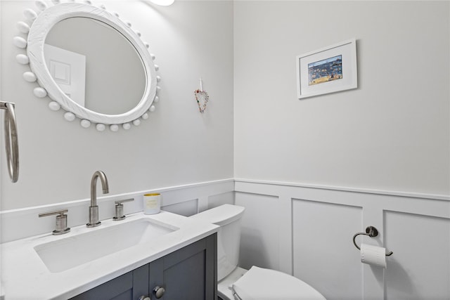 2 Robert Crisfield Pl, Rye, NY 10580 - bathroom with wainscoting, toilet, vanity, and a decorative wall