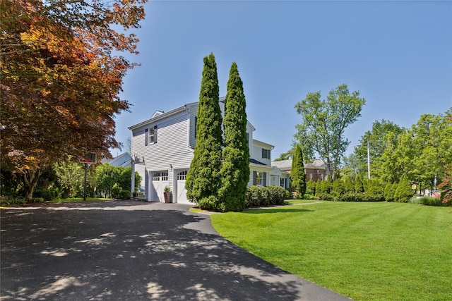 2 Robert Crisfield Pl, Rye, NY 10580 - view of side of home featuring an attached garage, a lawn, and asphalt driveway
