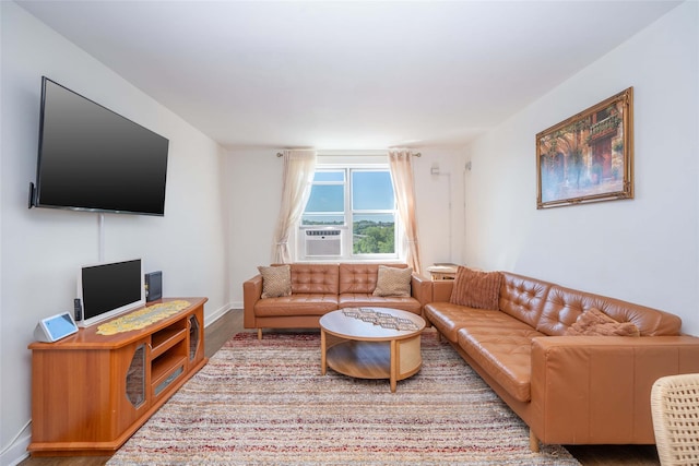 living room with wood finished floors, cooling unit, and baseboards