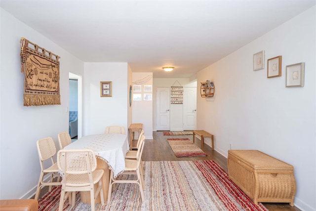 dining area with wood finished floors and baseboards