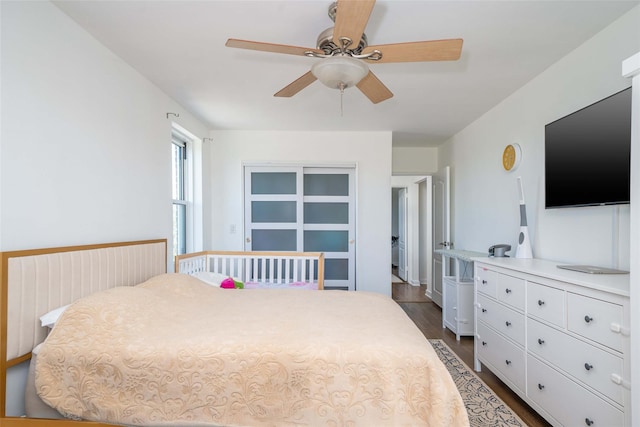 bedroom featuring dark wood-type flooring and ceiling fan