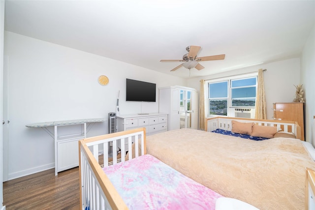 bedroom with dark wood finished floors, baseboards, and ceiling fan