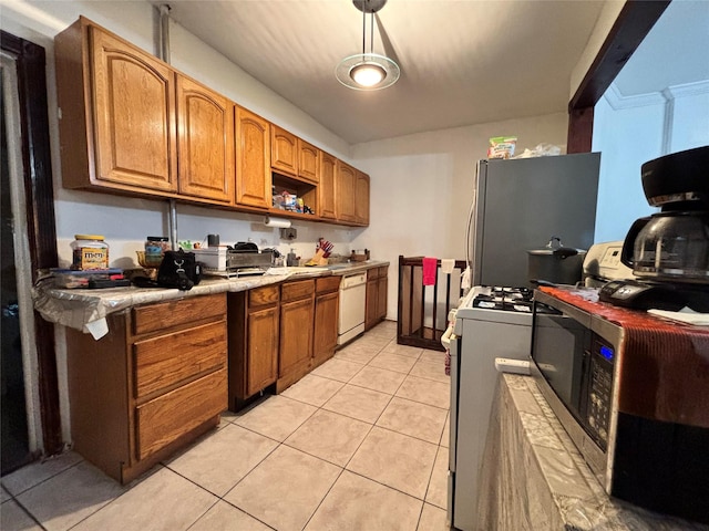 556 Van Cortlandt Park Ave, Yonkers, NY 10705 - kitchen with stainless steel appliances, light countertops, light tile patterned floors, brown cabinetry, and a sink