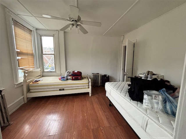 556 Van Cortlandt Park Ave, Yonkers, NY 10705 - bedroom with radiator heating unit, dark wood finished floors, and a ceiling fan
