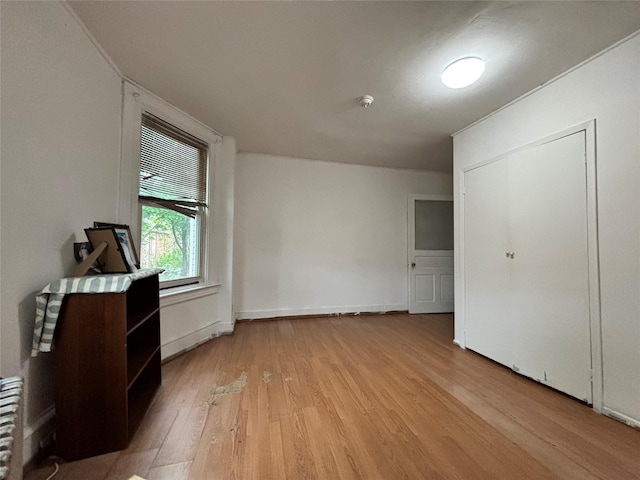 556 Van Cortlandt Park Ave, Yonkers, NY 10705 - unfurnished bedroom featuring light wood-style flooring and radiator heating unit