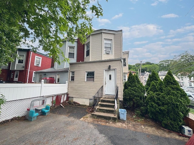 556 Van Cortlandt Park Ave, Yonkers, NY 10705 - view of front facade featuring entry steps, fence, and cooling unit
