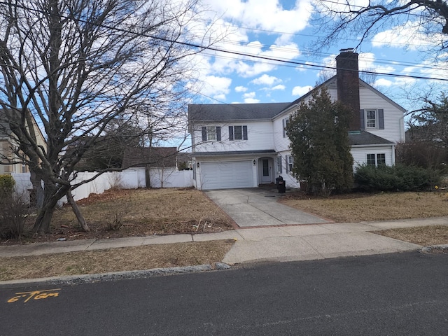 15 Mckenna Ave, North Baldwin, NY 11510 - traditional-style home featuring fence, a chimney, driveway, and a garage