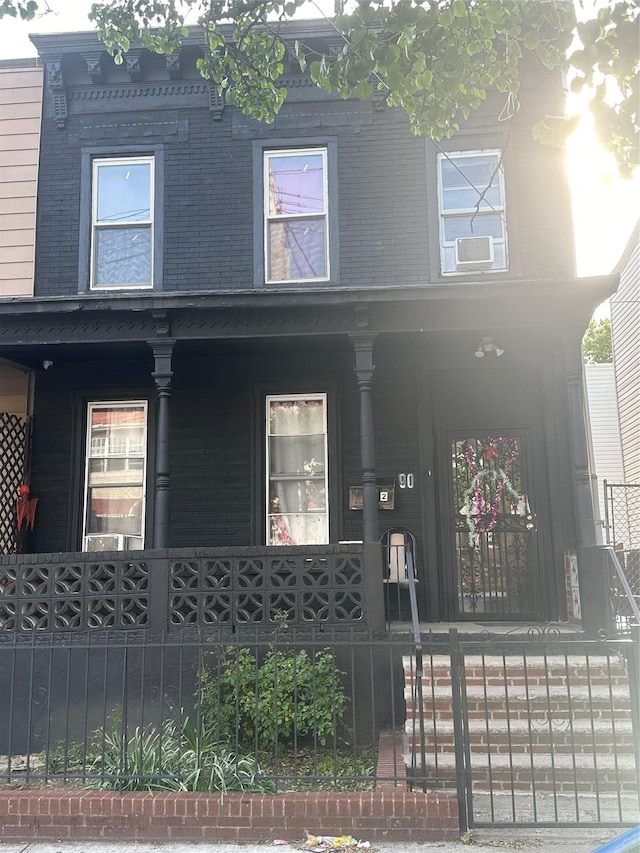 90 Wyona St, Brooklyn, NY 11207 - view of front of house featuring covered porch and a fenced front yard