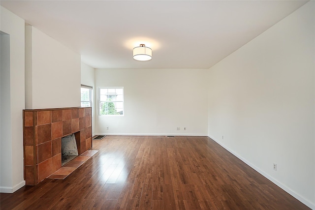 114 Frankel Blvd, Merrick, NY 11566 - unfurnished living room with dark wood-type flooring, a tile fireplace, and baseboards