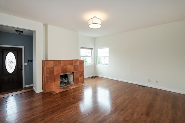 114 Frankel Blvd, Merrick, NY 11566 - unfurnished living room with dark wood-type flooring, baseboards, and a fireplace