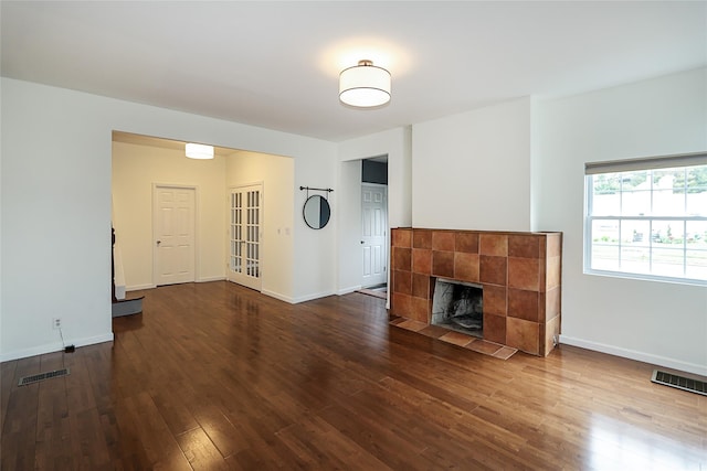 114 Frankel Blvd, Merrick, NY 11566 - unfurnished living room with wood finished floors, baseboards, and a tiled fireplace