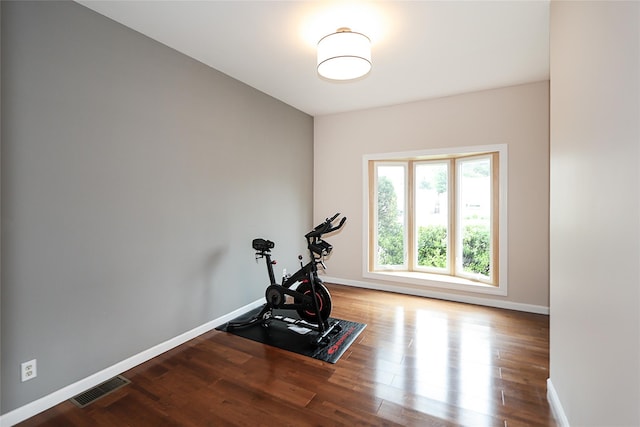 114 Frankel Blvd, Merrick, NY 11566 - exercise room featuring wood finished floors and baseboards