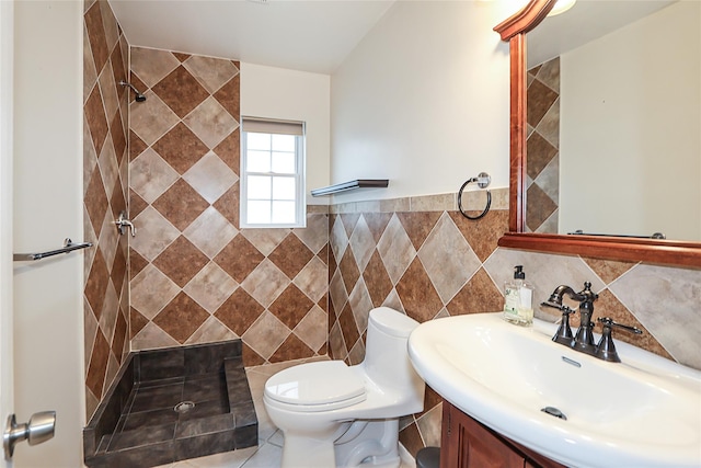 114 Frankel Blvd, Merrick, NY 11566 - full bathroom featuring tile walls, tiled shower, toilet, vanity, and a wainscoted wall