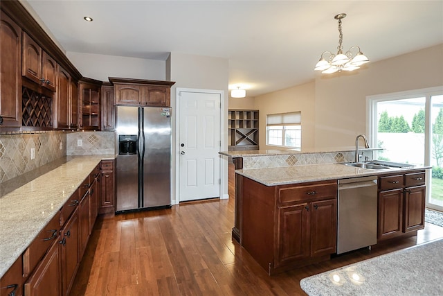 114 Frankel Blvd, Merrick, NY 11566 - kitchen featuring stainless steel appliances, a sink, dark wood finished floors, a chandelier, and tasteful backsplash
