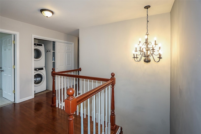 114 Frankel Blvd, Merrick, NY 11566 - corridor with stacked washer / dryer, an upstairs landing, a chandelier, wood finished floors, and baseboards