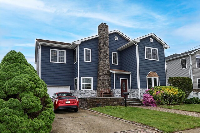 114 Frankel Blvd, Merrick, NY 11566 - view of front of house with a chimney, concrete driveway, a garage, and a front yard