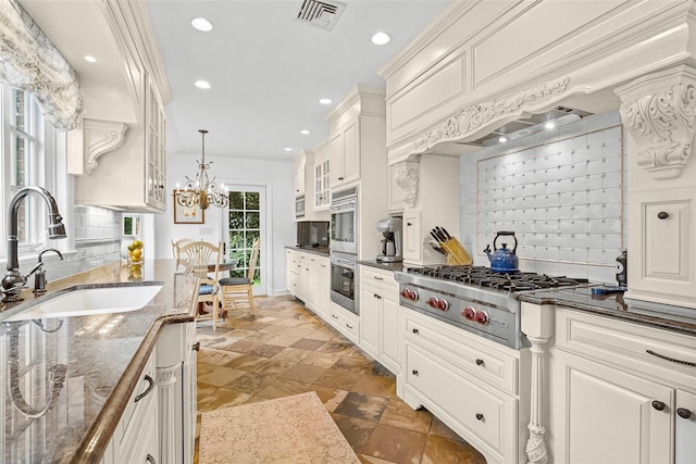 17 Byron Ln, Larchmont, NY 10538 - kitchen with a sink, appliances with stainless steel finishes, backsplash, glass insert cabinets, and recessed lighting