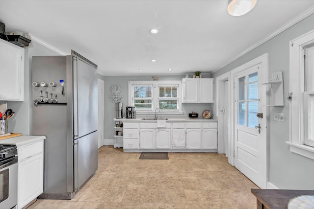 8 Townsend Blvd, Poughkeepsie, NY 12603 - kitchen featuring white cabinets, a sink, light countertops, electric stove, and ornamental molding