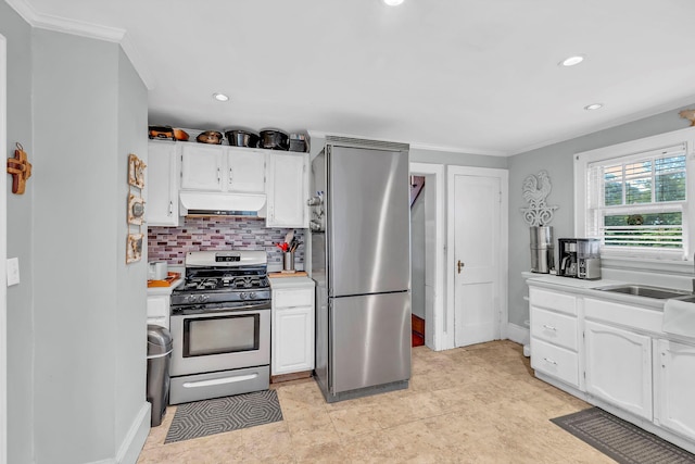 8 Townsend Blvd, Poughkeepsie, NY 12603 - kitchen with appliances with stainless steel finishes, under cabinet range hood, white cabinetry, backsplash, and ornamental molding