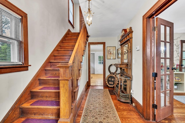 8 Townsend Blvd, Poughkeepsie, NY 12603 - staircase with wood finished floors, a chandelier, and baseboards