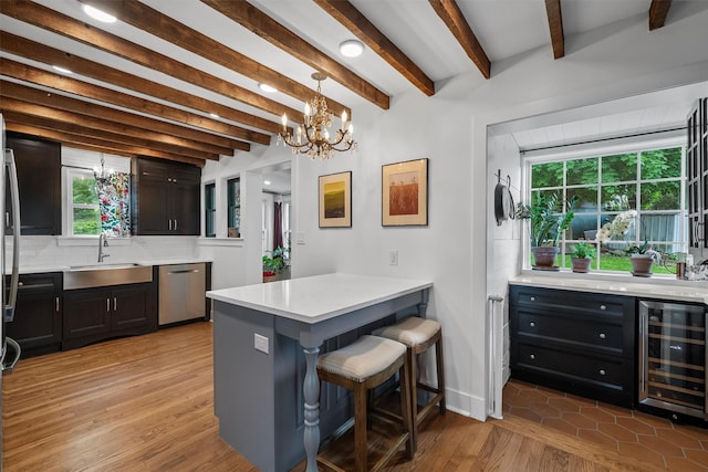 1219 Maple Ave, Peekskill, NY 10566 - kitchen featuring a sink, beverage cooler, dishwasher, a peninsula, and a chandelier