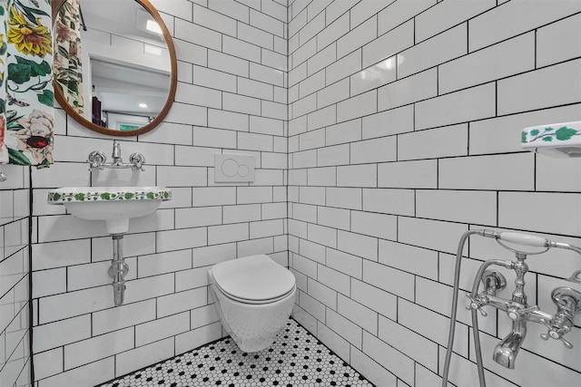 1219 Maple Ave, Peekskill, NY 10566 - bathroom with tile walls, toilet, tile patterned floors, and a sink