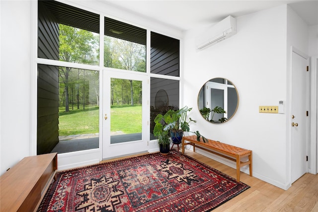 82 Moadock Rd, Millerton, NY 12546 - entryway with wood finished floors, a wall unit AC, and plenty of natural light
