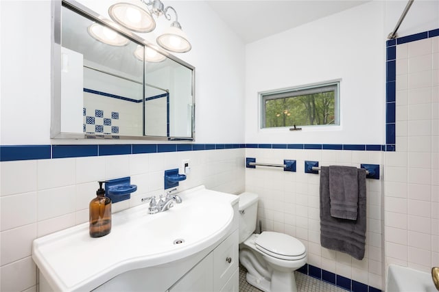 82 Moadock Rd, Millerton, NY 12546 - full bathroom with tile walls, toilet, vanity, and a wainscoted wall