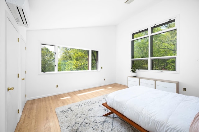 82 Moadock Rd, Millerton, NY 12546 - bedroom with a wall mounted air conditioner, light wood finished floors, and baseboards