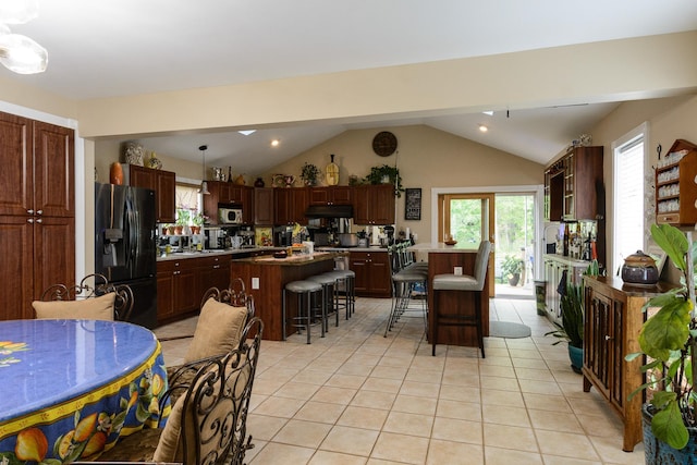 11 Crescent St, Mastic, NY 11950 - dining space featuring light tile patterned floors, lofted ceiling, and recessed lighting
