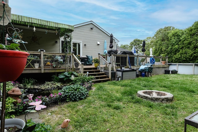 11 Crescent St, Mastic, NY 11950 - view of grassy yard featuring an outdoor fire pit, a deck, and an outdoor pool