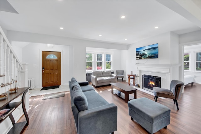 26 Alta Dr, Mount Vernon, NY 10552 - living area featuring healthy amount of natural light, a fireplace with flush hearth, radiator heating unit, wood finished floors, and recessed lighting