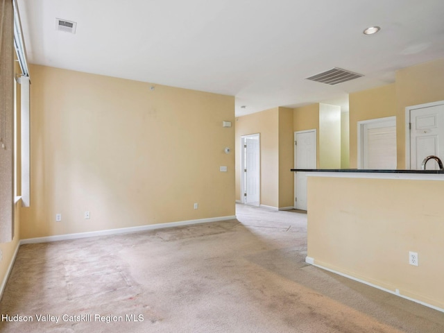 212 Commons Ln, Saugerties, NY 12477 - empty room featuring baseboards, light carpet, and a sink